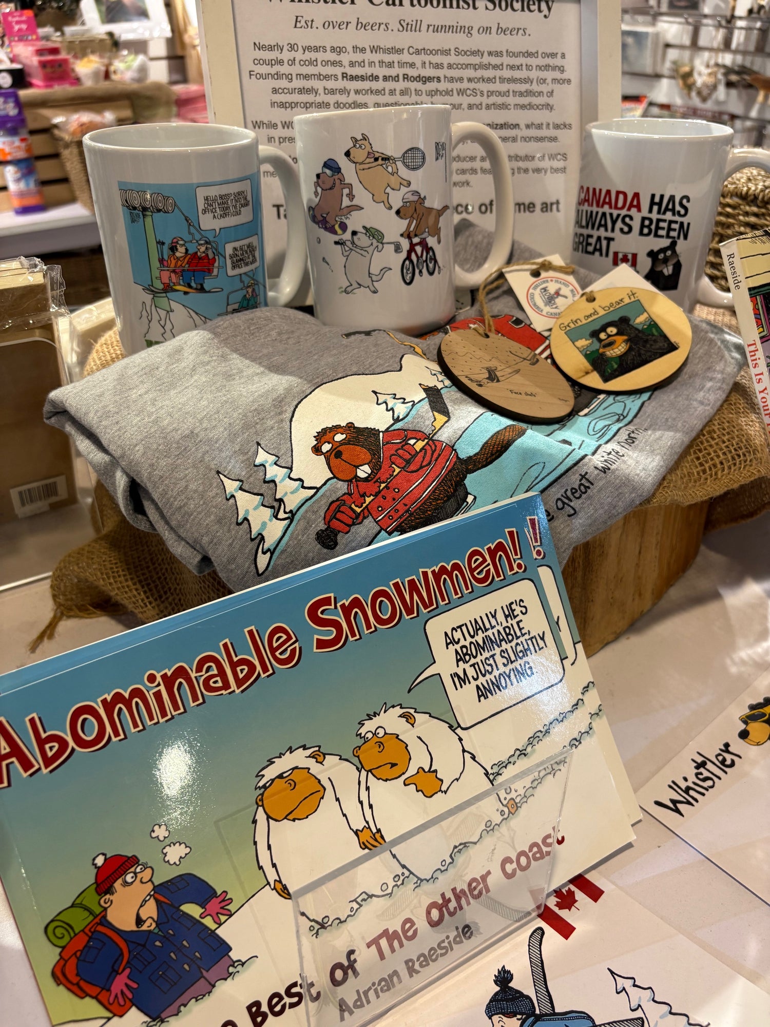 Whistler Cartoonist Society products – mugs, ornaments, T-shirt, and cartoon book